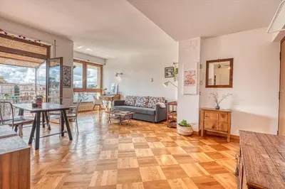 a living room with a table and a couch at Matilde's view apartment Saint Peter in Rome