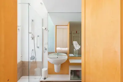 a bathroom with a sink and a glass shower at iFlat The Carpet Apartment in Rome