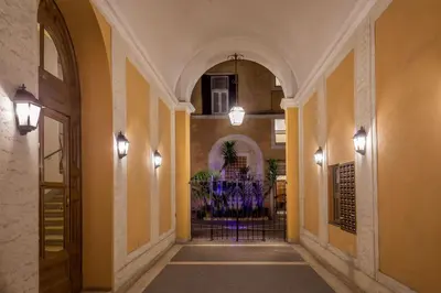 a hallway of a building with a gate and lights at Navona Gold Apartment in Rome