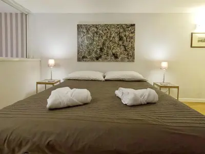 a bedroom with a large bed with two white pillows at Navona Gold Apartment in Rome