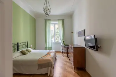 a bedroom with a bed and a tv in it at iFlat The gem of the center in Rome