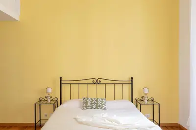 a bedroom with a bed with two side tables at iFlat The gem of the center in Rome