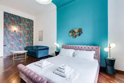 a bedroom with a bed and a blue wall at BMGA l Luxury 3Bdr Apt with Stunning View in City Center in Rome