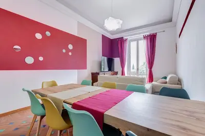 a dining room with a table and chairs at BMGA l Luxury 3Bdr Apt with Stunning View in City Center in Rome