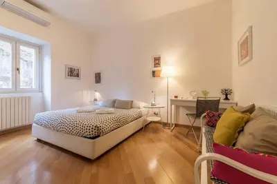 a bedroom with a bed and a couch in it at iFlat Apê Ponte Sisto in Rome
