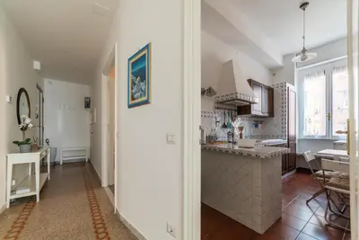 a kitchen with white walls and a large island in a room at GuestHost - Bright APT - San Pietro & Castel Sant'Angelo in Rome