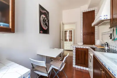 a kitchen with a table and two chairs in it at GuestHost - Bright APT - San Pietro & Castel Sant'Angelo in Rome