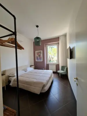 a bedroom with a large bed and a window at Amina's House Lab in Rome