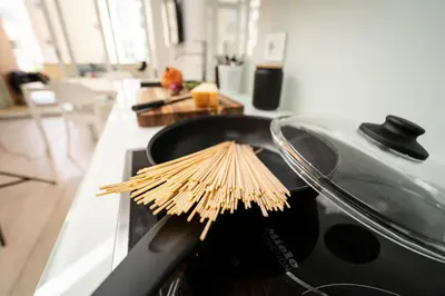 a bunch of bamboo sticks in a pan on a stove at Ancient Rome Apartment in Rome
