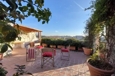 a patio with chairs and a table on a patio at Beautiful Loft in Ponte Milvio with terrace in Rome
