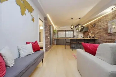 a living room with a couch and a brick wall at Casina degli Eroi in Rome