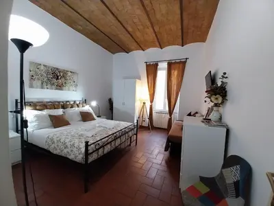 a bedroom with a bed with a wooden ceiling at The Artist House in Rome