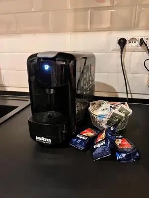 a coffee maker sitting on top of a counter with chips at Appartamento nel cuore di Roma in Rome