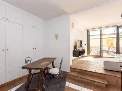 a living room with a table and chairs and a couch at Panoramic Terrace Trastevere in Rome