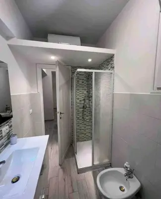 a bathroom with a sink and a shower and a toilet at Bignami street in Rome