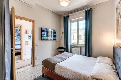 a bedroom with a bed and a window and a mirror at Otranto 36 in Rome