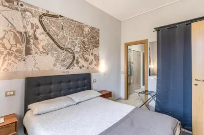 a bedroom with a bed and a map on the wall at Otranto 36 in Rome