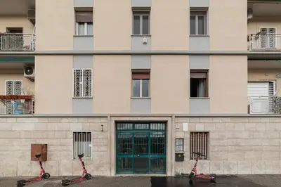 two scooters parked in front of a building at GuestHost - Sunny Apartment Piramide in Rome