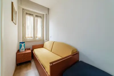 a small room with a couch and a window at GuestHost - Sunny Apartment Piramide in Rome