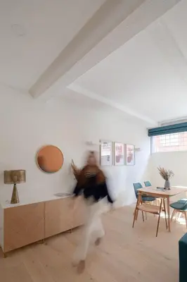 a person running in a room with a table and chairs at Noah Charme in Rome