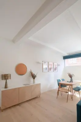 a white living room with a table and chairs at Noah Charme in Rome