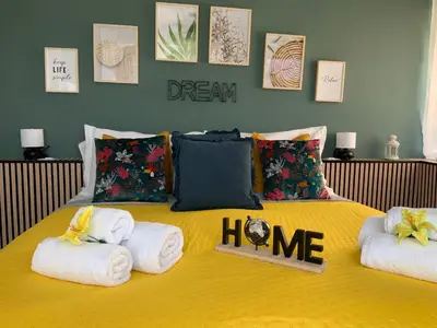 a yellow bed with towels and a sign that says dream havoc at Home K&Y Elite Pineta in Rome
