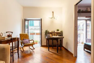 a living room with a table and a desk at Appartamento via di San Martino ai Monti in Rome