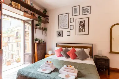 a bedroom with a bed with towels on it at Appartamento via di San Martino ai Monti in Rome