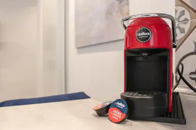 a red appliance sitting on top of a counter at Ziani 5 Rome Vatican Apartment in Rome