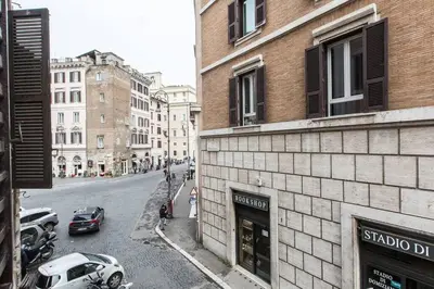 a city street with cars parked on the side of a building at Navona Atmosphere A few meters from Piazza Navona !! in Rome