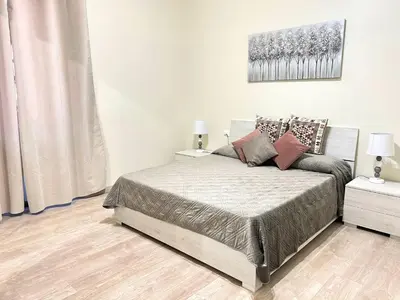 a bedroom with a bed with two night stands and two lamps at suite magenta in Rome