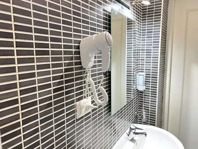 a bathroom with a sink and a mirror at suite magenta in Rome