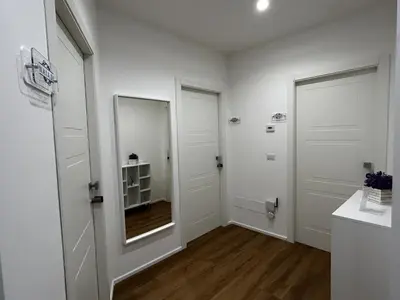 a hallway with two white doors and a mirror at IL NINFEO San Giovanni ROMA in Rome