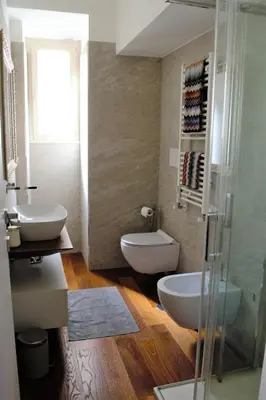 a bathroom with two sinks and a glass shower at Eternal City Apartment in Rome
