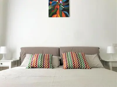 a bed with two pillows on top of it at Eternal City Apartment in Rome