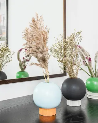 three vases sitting on a table with plants in them at Suites Campo de' Fiori - Zen18-19-20 in Rome