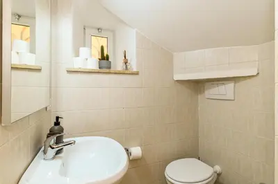 a bathroom with a sink and a toilet at Cozy & Central with Private Entrance by NDP rent in Rome
