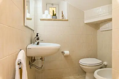 a bathroom with a sink and a toilet at Cozy & Central with Private Entrance by NDP rent in Rome