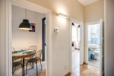 a kitchen and dining room with a table and chairs at Borgo Vittorio 2 bdr 2 bath St Peter's in Rome