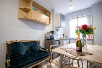 a living room with a couch and a table with a vase of flowers at DOMUS PETRI- CASA A S. PIETRO in Rome