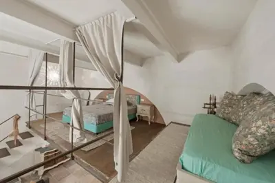 a bedroom with a bed and a window at Shabby Loft in Colosseum in Rome
