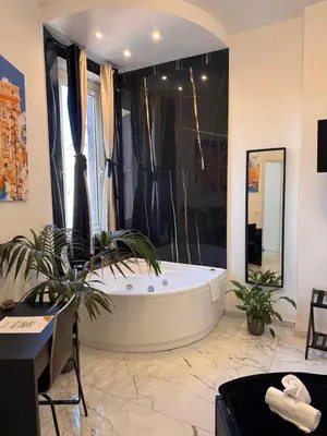 a bathroom with a large tub in a room at Re di Roma Rooftop in Rome