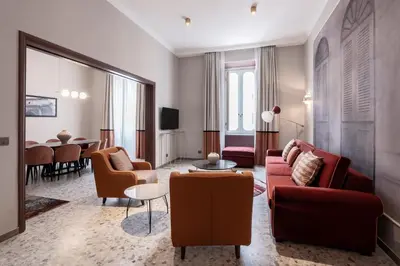 a living room with a couch and chairs and a table at Be Mate Castel Sant'Angelo in Rome