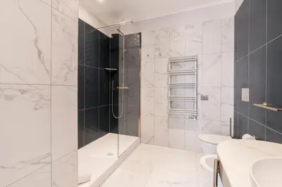 a bathroom with a shower and a toilet at Be Mate Castel Sant'Angelo in Rome