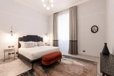 a bedroom with a bed and a clock on the wall at Be Mate Castel Sant'Angelo in Rome