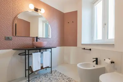 a bathroom with a sink and a mirror at Be Mate Trastevere II in Rome