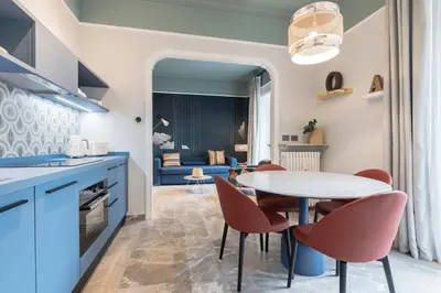 a kitchen and dining room with a table and chairs at Be Mate Trastevere III in Rome