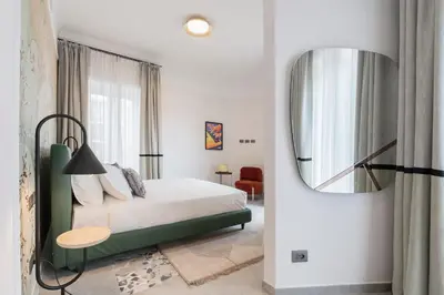 a bedroom with a bed and a mirror on the wall at Be Mate Trastevere III in Rome