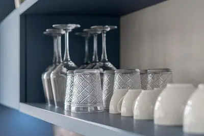 a shelf with several glass vases on it at Be Mate Trastevere III in Rome