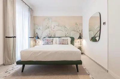 a bedroom with a bed with a floral wall at Be Mate Trastevere III in Rome